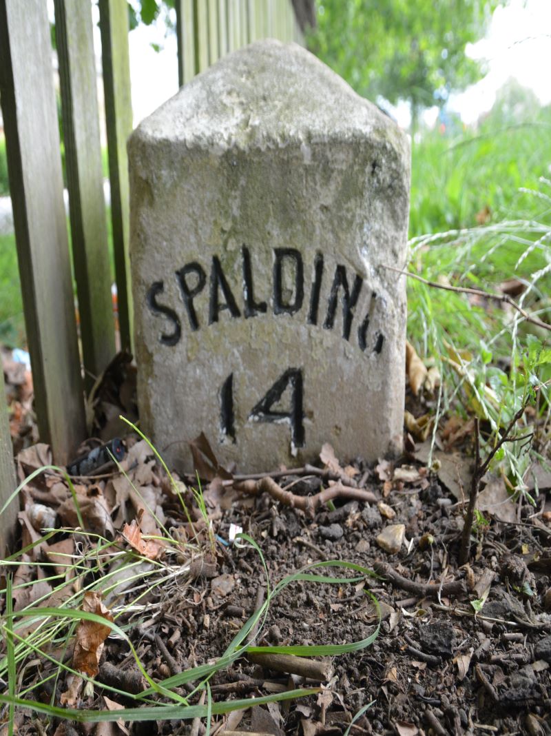 Milestone half-buried in the bank
                            opposite the Pincushion on the old road to Spalding