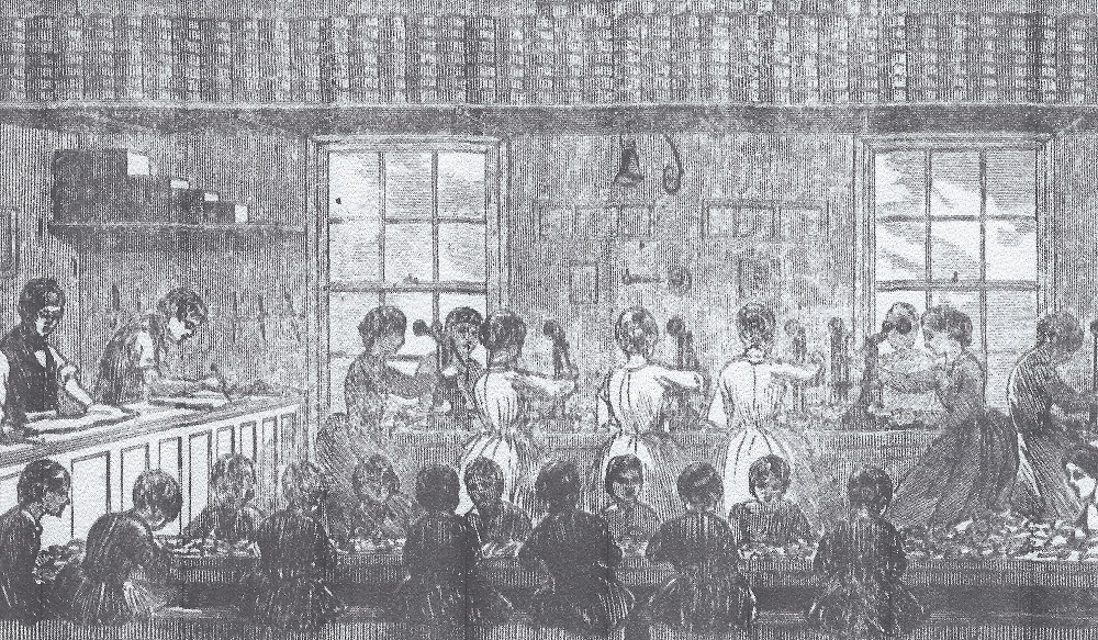 A black and white illustration of a label making factory. A table of women are working in the background. In the foreground a long table with small children are also working while seated. 